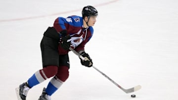 Jan 14, 2016; Denver, CO, USA; Colorado Avalanche defenseman Nikita Zadorov (16) controls the puck in the second period against the New Jersey Devils at the Pepsi Center. Mandatory Credit: Ron Chenoy-USA TODAY Sports