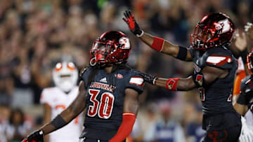 LOUISVILLE, KY - SEPTEMBER 16: Khane Pass #30 of the Louisville Cardinals celebrates with Zykiesis Cannon #24 after a tackle for loss against the Clemson Tigers in the first quarter of a game at Papa John's Cardinal Stadium on September 16, 2017 in Louisville, Kentucky. (Photo by Joe Robbins/Getty Images)