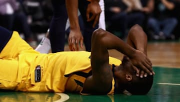 BOSTON, MA - DECEMBER 15: Derrick Favors #15 of the Utah Jazz goes down after a drive to the basket by Jaylen Brown #7 of the Boston Celtics during the during the second quarter of the game at TD Garden on December 15, 2017 in Boston, Massachusetts. NOTE TO USER: User expressly acknowledges and agrees that, by downloading and or using this photograph, User is consenting to the terms and conditions of the Getty Images License Agreement. (Photo by Omar Rawlings/Getty Images)