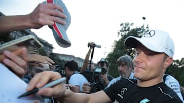 MILAN, ITALY - AUGUST 31: Valtteri Bottas of Finland and Mercedes GP signs autographs for fans prior to the drivers parade at Castello Sforzesco on August 31, 2017 in Milan, Italy. (Photo by Emilio Andreoli/Getty Images)