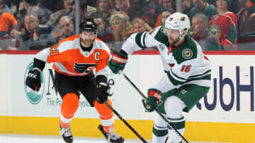 PHILADELPHIA, PA - JANUARY 14: Jason Zucker #16 of the Minnesota Wild looks to pass the puck against Claude Giroux #28 of the Philadelphia Flyers on January 14, 2019 at the Wells Fargo Center in Philadelphia, Pennsylvania. (Photo by Len Redkoles/NHLI via Getty Images)