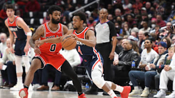 WASHINGTON, DC - MARCH 29: Ish Smith #4 of the Washington Wizards dribbles by Coby White #0 of the Chicago Bulls during a NBA basketball game at Capital One Arena on March 29, 2022 in Washington, DC. NOTE TO USER: User expressly acknowledges and agrees that, by downloading and or using this photograph, User is consenting to the terms and conditions of the Getty Images License Agreement. (Photo by Mitchell Layton/Getty Images)