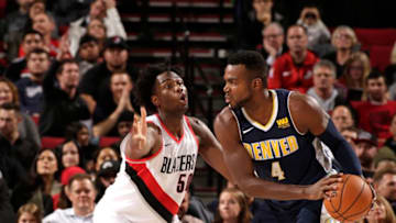 PORTLAND, OR - NOVEMBER 13: Paul Millsap #4 of the Denver Nuggets handles the ball against Caleb Swanigan #50 of the Portland Trail Blazers on November 13, 2017 at the Moda Center in Portland, Oregon. NOTE TO USER: User expressly acknowledges and agrees that, by downloading and or using this Photograph, user is consenting to the terms and conditions of the Getty Images License Agreement. Mandatory Copyright Notice: Copyright 2017 NBAE (Photo by Cameron Browne/NBAE via Getty Images)