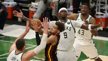 MILWAUKEE, WISCONSIN - JUNE 25: Trae Young #11 of the Atlanta Hawks is pressured by Brook Lopez #11 and Bobby Portis #9 of the Milwaukee Bucks during the second half in game two of the Eastern Conference Finals at Fiserv Forum on June 25, 2021 in Milwaukee, Wisconsin. NOTE TO USER: User expressly acknowledges and agrees that, by downloading and or using this photograph, User is consenting to the terms and conditions of the Getty Images License Agreement. (Photo by Stacy Revere/Getty Images)