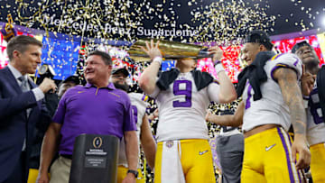 NEW ORLEANS, LOUISIANA - JANUARY 13: Head coach Ed Orgeron of the LSU Tigers, Joe Burrow #9 of the LSU Tigers and Grant Delpit #7 of the LSU Tigers celebrate with the trophy after defeating the Clemson Tigers 42-25 in the College Football Playoff National Championship game at Mercedes Benz Superdome on January 13, 2020 in New Orleans, Louisiana. (Photo by Kevin C. Cox/Getty Images)