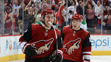 GLENDALE, AZ - OCTOBER 19: Clayton Keller #9 of the Arizona Coyotes smiles as he skates past teammate Max Domi #16 after scoring a goal against the Dallas Stars during the third period at Gila River Arena on October 19, 2017 in Glendale, Arizona. (Photo by Norm Hall/NHLI via Getty Images)