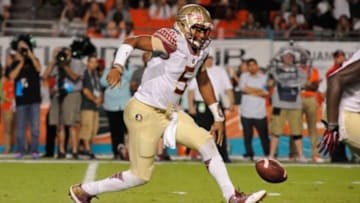 Nov 15, 2014; Miami Gardens, FL, USA; Florida State Seminoles quarterback Jameis Winston (5) fumbles the snap against the Miami Hurricanes in the first half at Sun Life Stadium. Mandatory Credit: David Manning-USA TODAY Sports