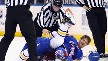 Apr 27, 2021; New York, NY, USA; Dylan Cozens #24 of the Buffalo Sabres and Kevin Rooney #17 of the New York Rangers fight during the third period at Madison Square Garden on April 27, 2021 in New York City. Mandatory Credit: Bruce Bennett/Pool Photo-USA TODAY Sports