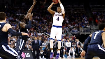 Mar 26, 2016; Louisville, KY, USA; Kansas Jayhawks guard Devonte' Graham (4) shoots the ball against Villanova Wildcats forward Daniel Ochefu (23) during the second half of the south regional final of the NCAA Tournament at KFC YUM!. Mandatory Credit: Aaron Doster-USA TODAY Sports