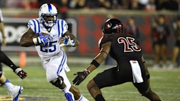 Oct 14, 2016; Louisville, KY, USA; Duke Blue Devils running back Jela Duncan (25) runs the ball against Louisville Cardinals safety Josh Harvey-Clemons (25) during the second quarter at Papa John