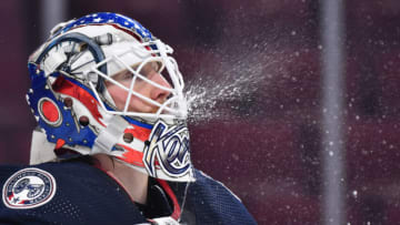 MONTREAL, QC - JANUARY 30: Goaltender Joonas Korpisalo #70 of the Columbus Blue Jackets sprays water during the first period against the Montreal Canadiens at Centre Bell on January 30, 2022 in Montreal, Canada. The Columbus Blue Jackets defeated the Montreal Canadiens 6-3. (Photo by Minas Panagiotakis/Getty Images)
