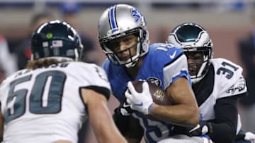 Nov 26, 2015; Detroit, MI, USA; Detroit Lions wide receiver Golden Tate (15) runs with the ball against Philadelphia Eagles cornerback Byron Maxwell (31) and linebacker Kiko Alonso (50) during the first quarter of a NFL game on Thanksgiving at Ford Field. Mandatory Credit: Raj Mehta-USA TODAY Sports