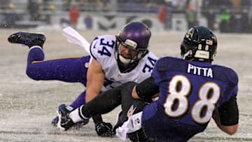 BALTIMORE, MD - DECEMBER 08: Tight end Dennis Pitta #88 of the Baltimore Ravens scores a touchdown past free safety Andrew Sendejo #34 of the Minnesota Vikings in the fourth quarter at M&T Bank Stadium on December 8, 2013 in Baltimore, Maryland. The Baltimore Ravens won, 29-26. (Photo by Patrick Smith/Getty Images)