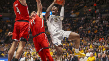 Feb 5, 2022; Morgantown, West Virginia, USA; West Virginia Mountaineers forward Gabe Osabuohien (3) drives and shoots against Texas Tech Red Raiders forward Marcus Santos-Silva (14) during the second half at WVU Coliseum. Mandatory Credit: Ben Queen-USA TODAY Sports