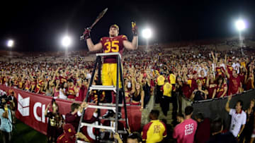 LOS ANGELES, CA - OCTOBER 24: Cameron Smith #35 of the USC Trojans celebrates a 42-24 win over the Utah Utes with fans after his three interception game at Los Angeles Memorial Coliseum on October 24, 2015 in Los Angeles, California. (Photo by Harry How/Getty Images)