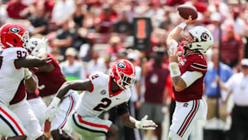 Sep 17, 2022; Columbia, South Carolina, USA; South Carolina Gamecocks quarterback Spencer Rattler (7) passes under pressure from Georgia Bulldogs linebacker Smael Mondon Jr. (2) in the second half at Williams-Brice Stadium. Mandatory Credit: Jeff Blake-USA TODAY Sports