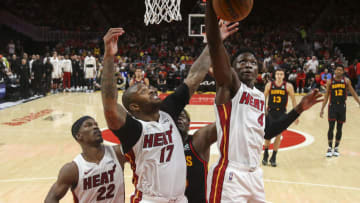 Miami Heat guard Victor Oladipo (4) grabs a rebound past forward P.J. Tucker (17) and forward Jimmy Butler (22) against the Atlanta Hawks(Brett Davis-USA TODAY Sports)