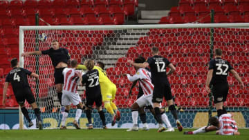 STOKE ON TRENT, ENGLAND - FEBRUARY 15: Phil Jagielka of Stoke City (bottom right) looks on as his header beats Martyn Waghorn of Huddersfield Town to score the first goal during the Sky Bet Championship between Stoke City and Huddersfield Town at Bet365 Stadium on February 15, 2023 in Stoke on Trent, England. (Photo by Malcolm Couzens/Getty Images)