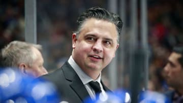 VANCOUVER, BC - DECEMBER 12: Head coach Travis Green of the Vancouver Canucks smiles as he looks on from the bench during their NHL game against the Carolina Hurricanes at Rogers Arena December 12, 2019 in Vancouver, British Columbia, Canada. Vancouver won 1-0. (Photo by Jeff Vinnick/NHLI via Getty Images)