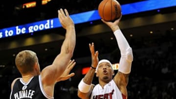 Oct 25, 2013; Miami, FL, USA; Miami Heat small forward Michael Beasley (8) shoots over Brooklyn Nets power forward Mason Plumlee (1) during the second half at American Airlines Arena. Mandatory Credit: Steve Mitchell-USA TODAY Sports