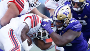 Nov 2, 2019; Seattle, WA, USA; Washington Huskies defensive lineman Levi Onwuzurike (95) tackles down Utah Utes running back Zack Moss (2) by the helmet during the third quarter at Husky Stadium. Mandatory Credit: Jennifer Buchanan-USA TODAY Sports