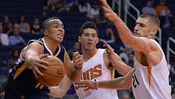 Oct 5, 2016; Phoenix, AZ, USA; Utah Jazz guard Dante Exum (11) makes a pass against Phoenix Suns guard Devin Booker (1) and center Alex Len (21) in the first half at Talking Stick Resort Arena. Mandatory Credit: Jennifer Stewart-USA TODAY Sports
