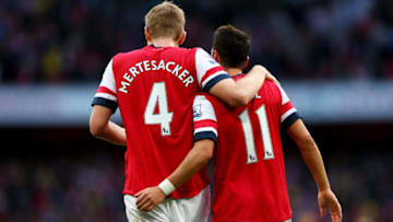 LONDON, ENGLAND - OCTOBER 19: Per Mertesacker and Mesut Oezil of Arsenal celebrate during the Barclays Premier League match between Arsenal and Norwich City at Emirates Stadium on October 19, 2013 in London, England. (Photo by Paul Gilham/Getty Images)