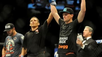 Sep 27, 2014; Las Vegas, NV, USA; Stephen Thompson (blue gloves) celebrates his victory over Patrick Cote (red gloves) during a welterweight fight during UFC 178 at MGM Grand Garden Arena. Mandatory Credit: Stephen R. Sylvanie-USA TODAY Sports