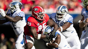 Devonte Wyatt tackles Kavosiey Smoke during the game against Kentucky.(Photo by Steven Limentani/ISI Photos/Getty Images)