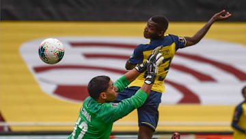 Ecuador's Moises Caicedo (R) scores against Uruguay's goalkeeper Martin Campana during their 2022 FIFA World Cup South American qualifier football match at the Rodrigo Paz Delgado Stadium in Quito on October 13, 2020, amid the COVID-19 novel coronavirus pandemic. (Photo by Rodrigo BUENDIA / AFP) (Photo by RODRIGO BUENDIA/AFP via Getty Images)