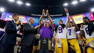 NEW ORLEANS, LOUISIANA - JANUARY 13: Joe Burrow #9 of the LSU Tigers celebrates with head coach Ed Orgeron of the LSU Tigers after defeating the Clemson Tigers 42-25 in the College Football Playoff National Championship game at Mercedes Benz Superdome on January 13, 2020 in New Orleans, Louisiana. (Photo by Kevin C. Cox/Getty Images)