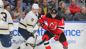 Dec 2, 2019; Buffalo, NY, USA; Buffalo Sabres center Jack Eichel (9) and New Jersey Devils center Nico Hischier (13) go after the puck during the first period at KeyBank Center. Mandatory Credit: Timothy T. Ludwig-USA TODAY Sports
