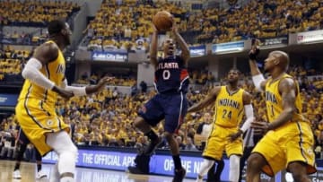 Apr 19, 2014; Indianapolis, IN, USA; Atlanta Hawks guard Jeff Teague (0) takes a shot against Indiana Pacers center Roy Hibbert (55) and forward David West (21) in game one during the first round of the 2014 NBA Playoffs at Bankers Life Fieldhouse. Mandatory Credit: Brian Spurlock-USA TODAY Sports