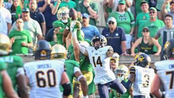 Sep 17, 2022; South Bend, Indiana, USA; Notre Dame Fighting Irish and California Bears players reach for a pass on the last play of the game at Notre Dame Stadium. The pass fell incomplete and Notre Dame won 24-17. Mandatory Credit: Matt Cashore-USA TODAY Sports