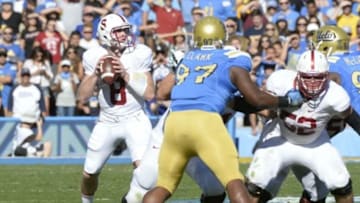 Nov 28, 2014; Pasadena, CA, USA; Stanford Cardinal quarterback Kevin Hogan (8) drops back to pass against the UCLA Bruins during the first half of the game at Rose Bowl. Mandatory Credit: Richard Mackson-USA TODAY Sports
