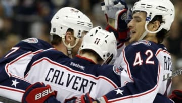 Apr 19, 2014; Pittsburgh, PA, USA; Columbus Blue Jackets defenseman Jack Johnson (left) and center Artem Anisimov (42) celebrate a goal by left wing Matt Calvert (11) against the Pittsburgh Penguins during the second period in game two of the first round of the 2014 Stanley Cup Playoffs at the CONSOL Energy Center. Mandatory Credit: Charles LeClaire-USA TODAY Sports