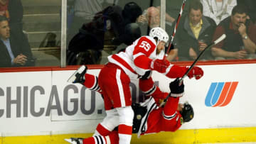 CHICAGO - MAY 22: Martin Havlat #24 of the Chicago Blackhawks checked hard to the ice by Niklas Kronwall #55 of the Detroit Red Wings during the first period of Game Three of the Western Conference Championship Round of the 2009 Stanley Cup Playoffs on May 22, 2009 at the United Center in Chicago, Illinois. (Photo by Jim Prisching/Getty Images)