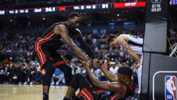 Bam Adebayo #13 of the Miami Heat helps to stand up to Jimmy Butler #22 of the Miami Heat(Photo by Manuel Velasquez/Getty Images)