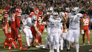 OAKLAND, CA - OCTOBER 19: Oakland Raiders running back DeAndre Washington (33) celebrates a touchdown as Vadal Alexander offers congratulations during an NFL game between the Kansas City Chiefs and the Oakland Raiders on October 19, 2017 at the Oakland-Alameda County Coliseum in Oakland, CA. (Photo by Daniel Gluskoter/Icon Sportswire via Getty Images)