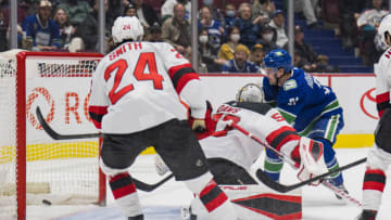 Mar 15, 2022; Vancouver, British Columbia, CAN; Vancouver Canucks forward Nils Hoglander (21) scores on New Jersey Devils goalie Nico Daws (50) in the first period at Rogers Arena. Mandatory Credit: Bob Frid-USA TODAY Sports