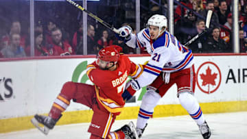 CALGARY, AB - MARCH 15: New York Rangers Center Brett Howden (21) checks Calgary Flames Defenceman T.J. Brodie (7) during the first period of an NHL game where the Calgary Flames hosted the New York Rangers on March 15, 2019, at the Scotiabank Saddledome in Calgary, AB. (Photo by Brett Holmes/Icon Sportswire via Getty Images)