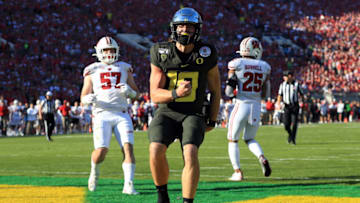 PASADENA, CALIFORNIA - JANUARY 01: Justin Herbert #10 of the Oregon Ducks celebrates after scoring a four yard touchdown against the Wisconsin Badgers during the first quarter in the Rose Bowl game presented by Northwestern Mutual at Rose Bowl on January 01, 2020 in Pasadena, California. (Photo by Sean M. Haffey/Getty Images)
