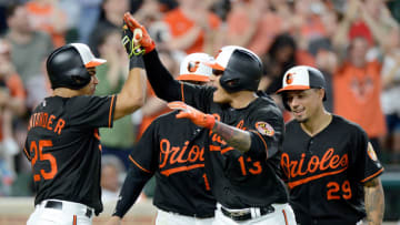 BALTIMORE, MD - MAY 11: Manny Machado #13 of the Baltimore Orioles celebrates with Anthony Santander #25, Chance Sisco #15 and Jace Peterson #29 after hitting a Grand Slam in the seventh inning against the Tampa Bay Rays at Oriole Park at Camden Yards on May 11, 2018 in Baltimore, Maryland. (Photo by Greg Fiume/Getty Images)