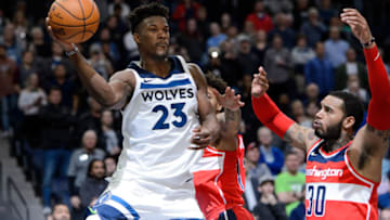 MINNEAPOLIS, MN - NOVEMBER 28: Jimmy Butler #23 of the Minnesota Timberwolves passes the ball against Kelly Oubre Jr. #12 and Mike Scott #30 of the Washington Wizards during the game on November 28, 2017 at the Target Center in Minneapolis, Minnesota. NOTE TO USER: User expressly acknowledges and agrees that, by downloading and or using this Photograph, user is consenting to the terms and conditions of the Getty Images License Agreement. (Photo by Hannah Foslien/Getty Images)