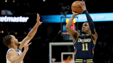 DENVER, COLORADO - APRIL 24: Monte Morris #11 of the Denver Nuggets puts up a shot over Stephen Curry #30 of the the Golden State Warriors in the first quarter during Game Four of the Western Conference First Round NBA Playoffs at Ball Arena on April 24, 2022 in Denver, Colorado. NOTE TO USER: User expressly acknowledges and agrees that, by downloading and/or using this photograph, User is consenting to the terms and conditions of the Getty Images License Agreement. (Photo by Matthew Stockman/Getty Images)