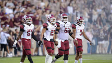 COLLEGE STATION, TX - OCTOBER 29: New Mexico State Aggies linebacker Rodney Butler (53), defensive back Jaden Wright (21), offensive lineman Anthony McMeans (62), and running back Larry Rose (3) walk on to the field for the coin toss before the New Mexico State Aggies vs Texas A