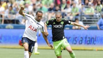 Jul 19, 2014; Seattle, WA, USA; Tottenham Hotspur midfielder Andros Townsend (17) and Seattle Sounders FC midfielder Osvaldo Alonso (6) fight for the ball during the first half at CenturyLink Field. Mandatory Credit: Steven Bisig-USA TODAY Sports