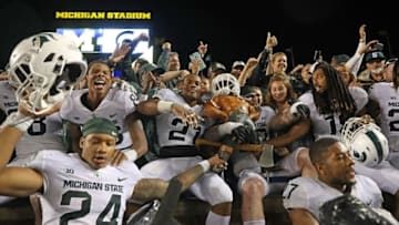 ANN ARBOR, MI - OCTOBER 07: Chris Frey #23 of Michigan State Spartans celebrate with his teammates a win over Michigan Wolverines with the Paul Banyun trophy at Michigan Stadium on October 7, 2017 in Ann Arbor, Michigan. Michigan State defeated Michigan 14-10. (Photo by Leon Halip/Getty Images)