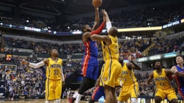 Jan 16, 2015; Indianapolis, IN, USA; Detroit Pistons center Greg Monroe (10) takes a shot against Indiana Pacers forward David West (21) at Bankers Life Fieldhouse. Mandatory Credit: Brian Spurlock-USA TODAY Sports