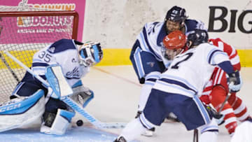 PORTLAND, ME - NOVEMBER 18: University of Maine goalie Rob McGovern get in front of the puck shot by Boston Universitys Brady Tkachuk, who is surrounded by Maine defensemen Brady Keeper and Mark Hamilton, during Hockey East action at the Cross Insurance Arena on Saturday November 18, 2017. (Photo by Carl D. Walsh/Portland Press Herald via Getty Images)